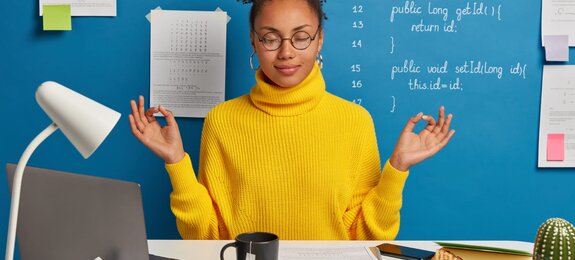 woman freelance worker does yoga in office