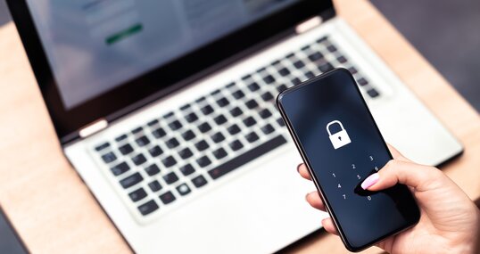 Phone password lock for mobile cyber security or login verification passcode in online bank app. Data privacy and protection from hacker, identity thief or cybersecurity threat. Laptop and smartphone.