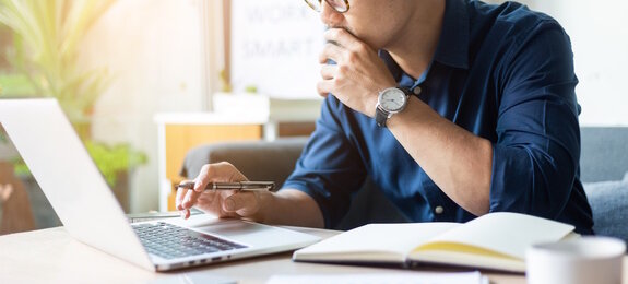 hand holding using texting cell phone and typing computer.businessman at workplace Thinking investment plan.chatting contact Investor.searching for information use internet.connecting people concept