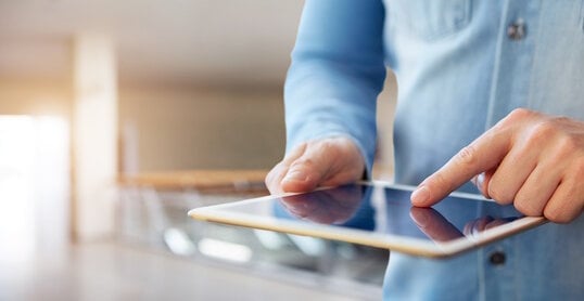 Male hand touching a digital tablet