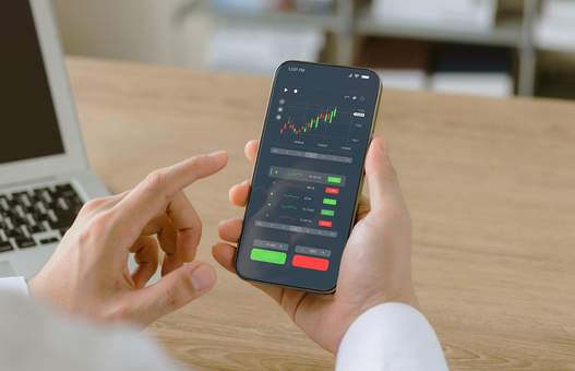 Businessmen work with stock market investments using smartphones to analyze trading data. smartphone with stock exchange graph on screen. Financial stock market