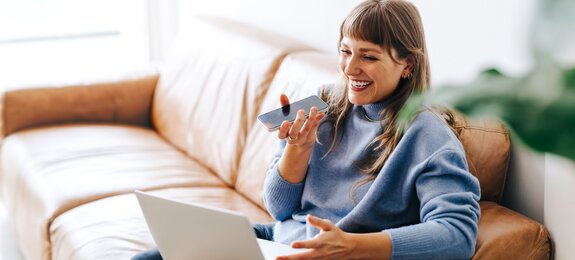 Happy young businesswoman having a phone call discussion in an office