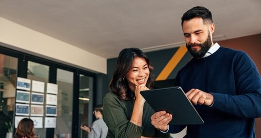 Business colleagues using a digital tablet in a boardroom