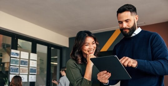 Business colleagues using a digital tablet in a boardroom