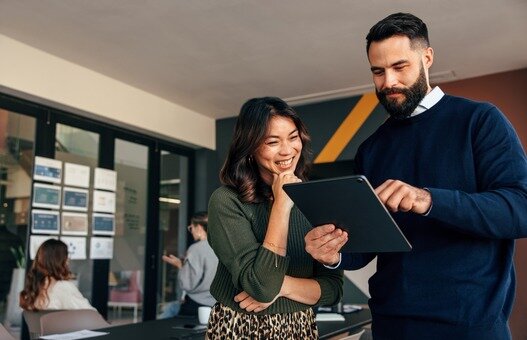 Business colleagues using a digital tablet in a boardroom