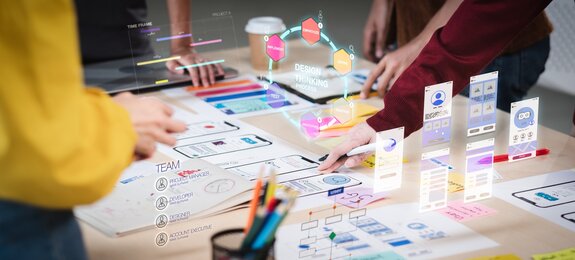 Close up ux developer and ui designer use augmented reality brainstorming about mobile app interface wireframe design on desk at modern office.Creative digital development agency