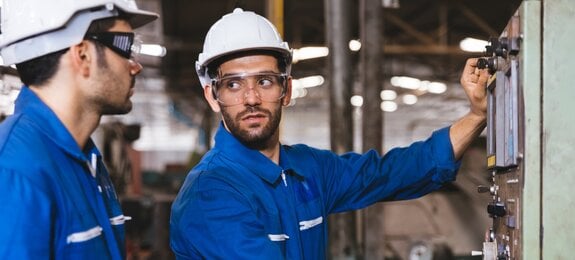 Group of Industrial factory maintenance engineers inspect relay protection system of machinery. Industry, Maintenance, Engineering and construction concept.