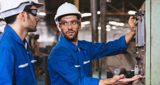 Group of Industrial factory maintenance engineers inspect relay protection system of machinery. Industry, Maintenance, Engineering and construction concept.