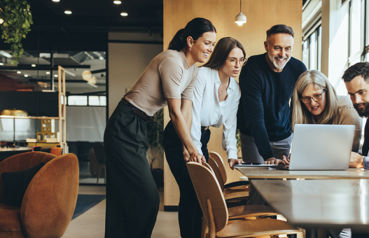 Group of businesspeople using a laptop together