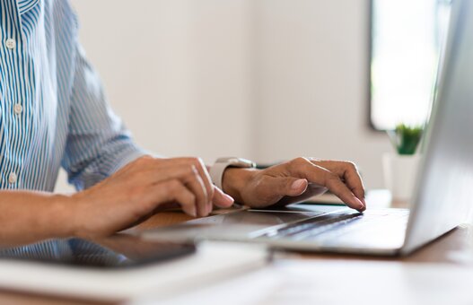 Close up hands of businesswoman typing on laptop keyboard to working and searching business data