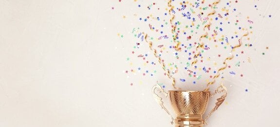 Trophy and confetti on light background, top view with space for text. Victory concept