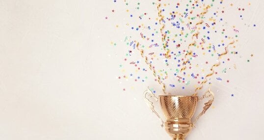 Trophy and confetti on light background, top view with space for text. Victory concept