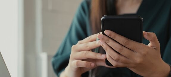 Close up of woman using mobile phone.