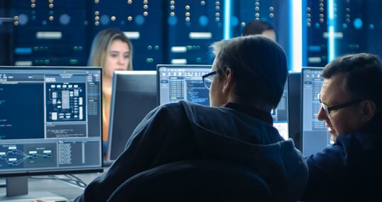 Two people discussing in front of a computer